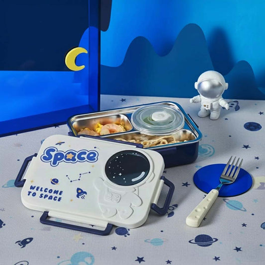Space-themed lunch set with container, plate, and cutlery on a tablecloth with space design.