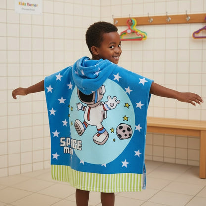 Child wearing a blue superhero cape with a cartoon character in a bathroom setting