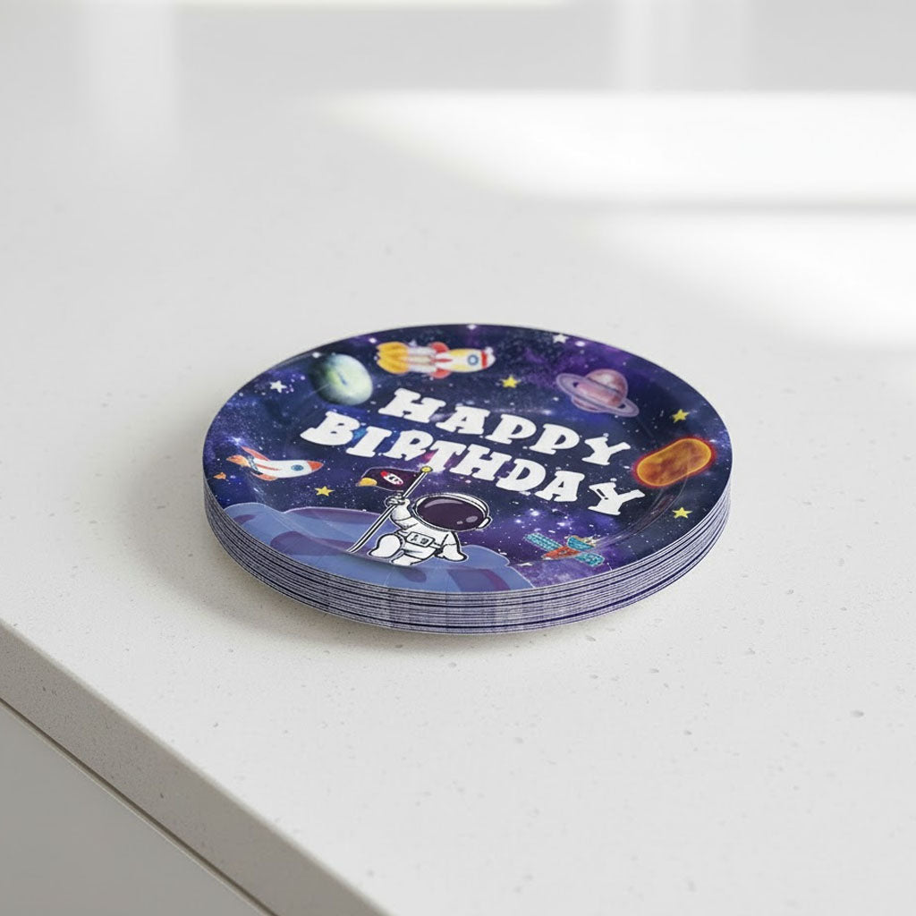 Stack of round party plates with space-themed design and 'Happy Birthday' text on a white surface.