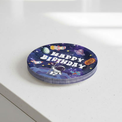 Stack of round party plates with space-themed design and 'Happy Birthday' text on a white surface.