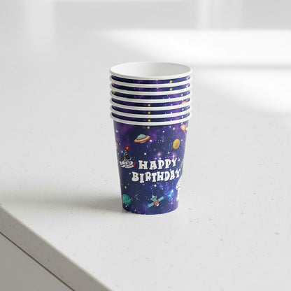 Stack of purple 'Happy Birthday' party cups with space-themed design on a white surface.