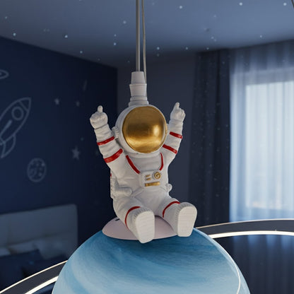 Astronaut figure on a ceiling lamp with space-themed decorations in the background